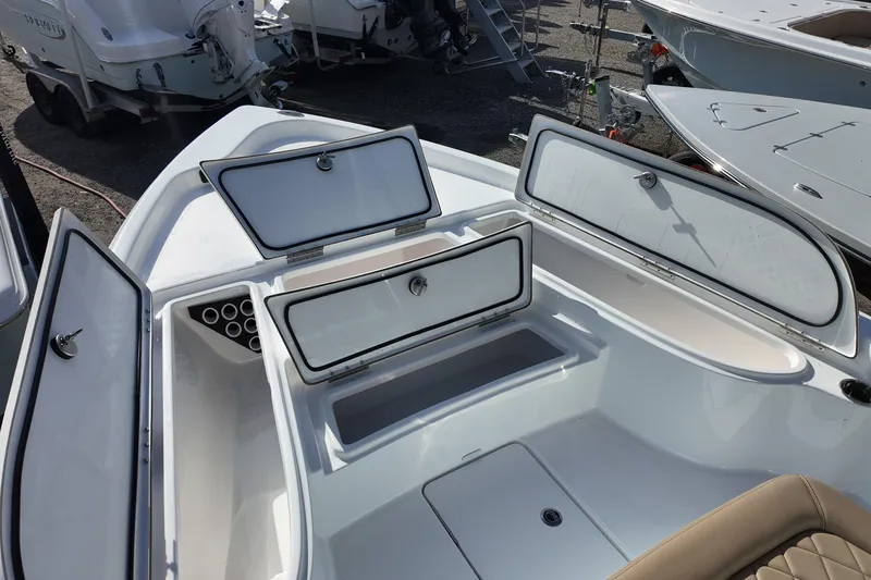 Slide: The Image of 2026 Blazer PureBay 2200 boat storage compartments open, showcasing spacious design. - 7