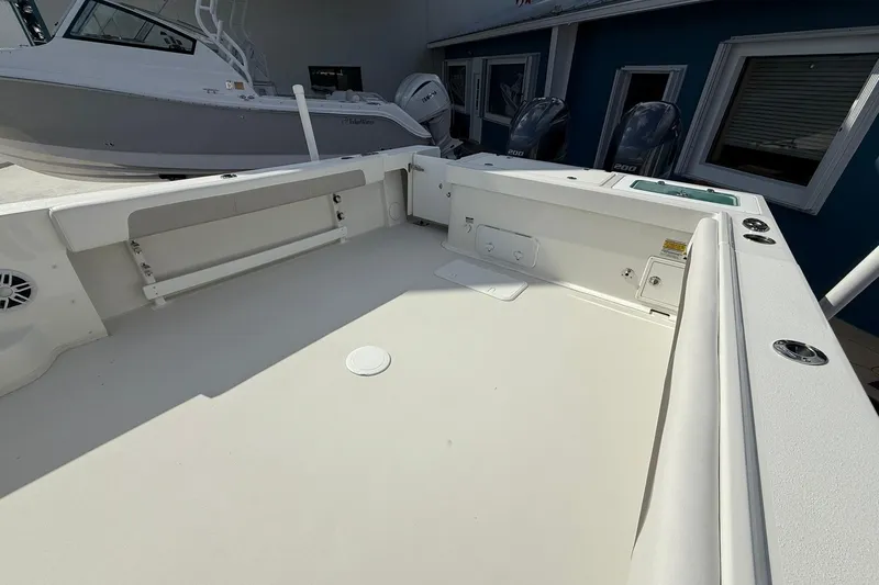 Slide: The Image of 2023 Parker 2520 XLD Sport Cabin boat deck with seating and storage. - 11