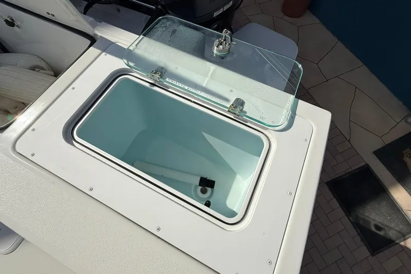 Slide: The Image of Open storage compartment on 2023 Parker 2520 XLD Sport Cabin boat. - 15