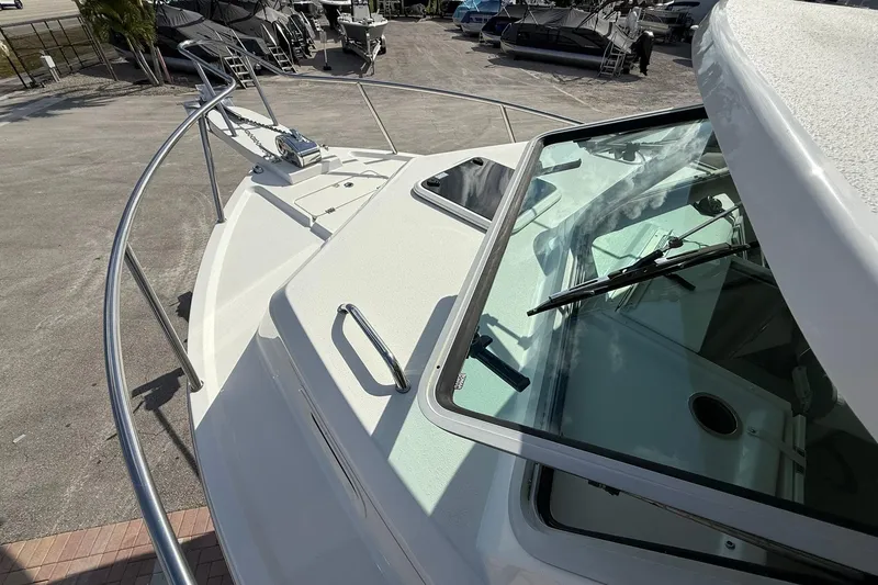 Slide: The Image of 2023 Parker 2520 XLD Sport Cabin boat, showcasing deck and cabin windshield. - 18