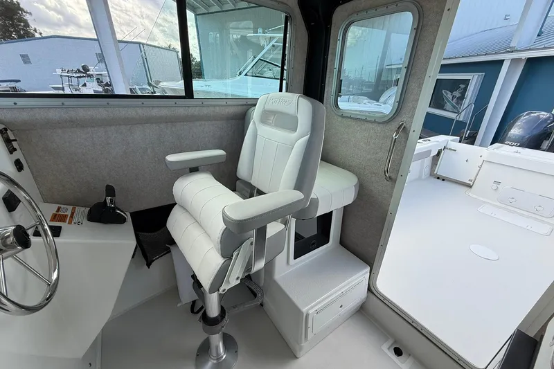 Slide: The Image of 2023 Parker 2520 XLD Sport Cabin interior with captain's chair and steering wheel. - 26