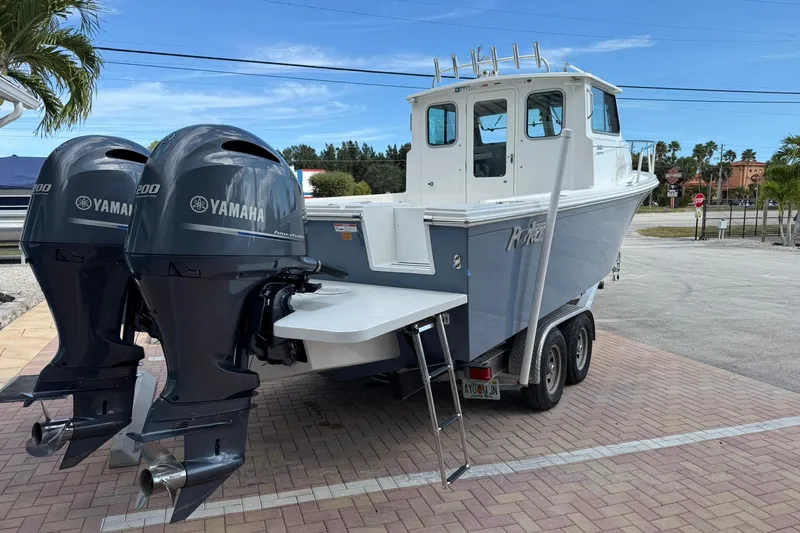 Slide: The Image of 2023 Parker 2520 XLD Sport Cabin boat with dual Yamaha engines on a trailer. - 5