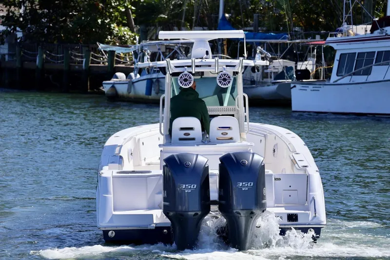 Slide: The Image of 2011 Everglades 320 Center Console boat with dual 350 V8 engines on water. - 20