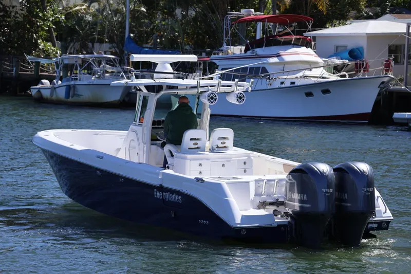 Slide: The Image of 2011 Everglades 320 Center Console boat with dual Yamaha engines on water. - 3