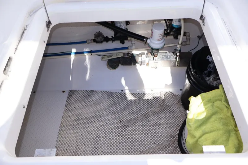 Slide: The Image of 2011 Everglades 320 Center Console storage compartment with equipment and cleaning supplies. - 7