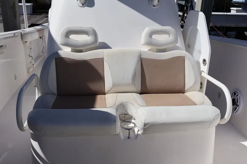 Slide: The Image of 2011 Everglades 320 Center Console boat seating with dual cushioned seats and armrests. - 8