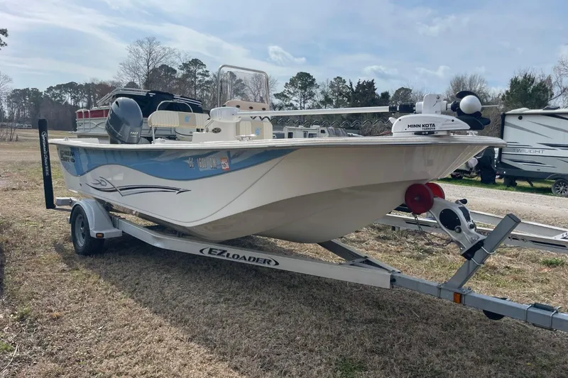 Slide: The Image of 2019 Carolina Skiff 198 DLV boat on trailer, parked outdoors. - 0