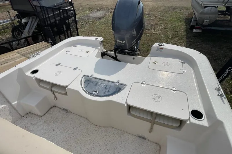 Slide: The Image of 2019 Carolina Skiff 198 DLV boat with Yamaha 90 engine, featuring storage compartments. - 12