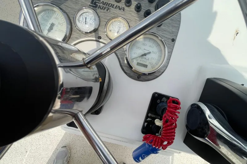 Slide: The Image of Steering console of 2019 Carolina Skiff 198 DLV with gauges and controls. - 14