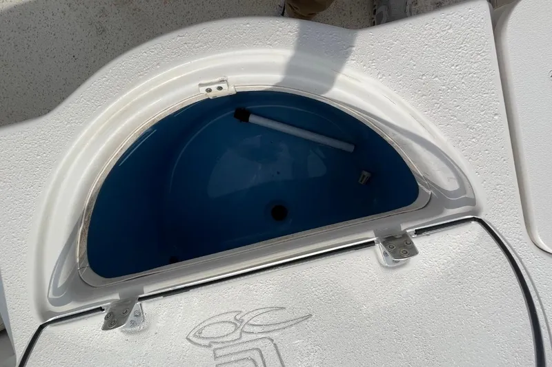 Slide: The Image of 2019 Carolina Skiff 198 DLV boat storage compartment with blue interior. - 17