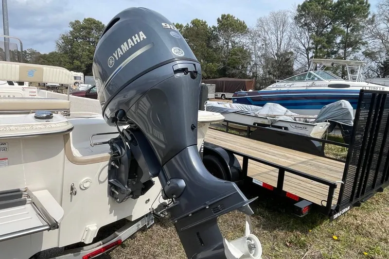 Slide: The Image of 2019 Carolina Skiff 198 DLV with Yamaha outboard motor in a boatyard setting. - 3