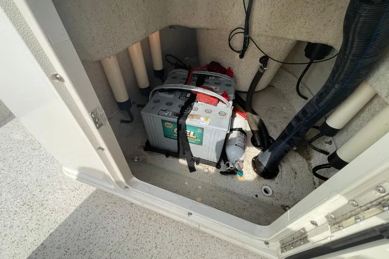 Slide: The Image of 2019 Carolina Skiff 198 DLV boat battery compartment with cables and fire extinguisher. - 30