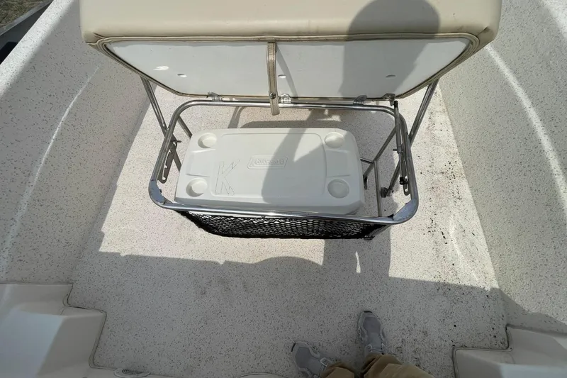Slide: The Image of 2019 Carolina Skiff 198 DLV boat interior with cooler and seating. - 31