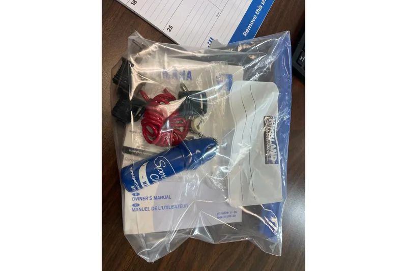 Slide: The Image of 2019 Carolina Skiff 198 DLV owner's manual and accessories in a clear plastic bag. - 35