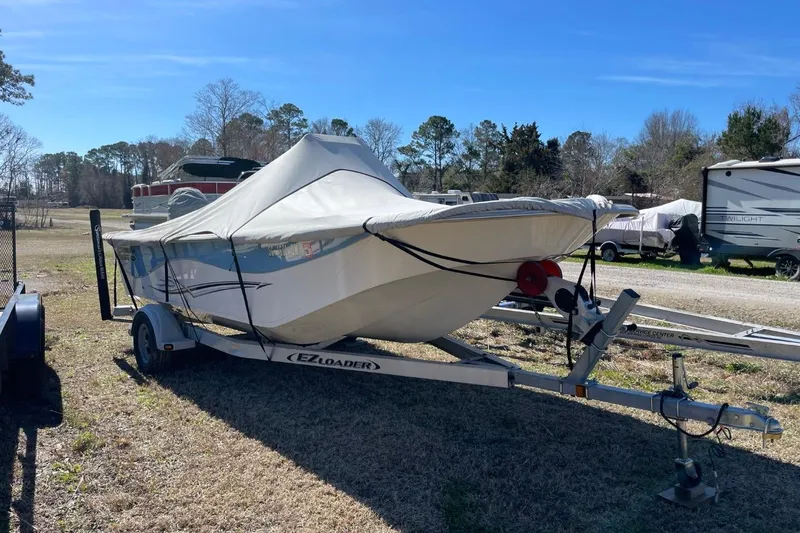 Slide: The Image of 2019 Carolina Skiff 198 DLV boat on trailer, covered, in outdoor setting. - 36