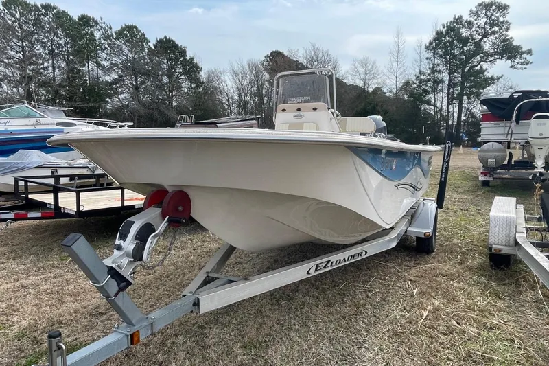 Slide: The Image of 2019 Carolina Skiff 198 DLV boat on trailer, parked outdoors. - 5