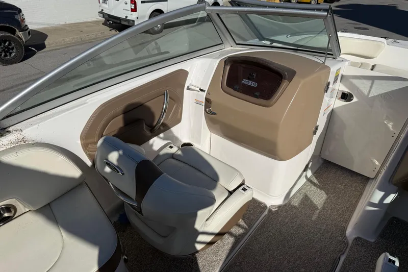Slide: The Image of 2015 Chaparral 244 Sunesta boat interior with seating and dashboard. - 12