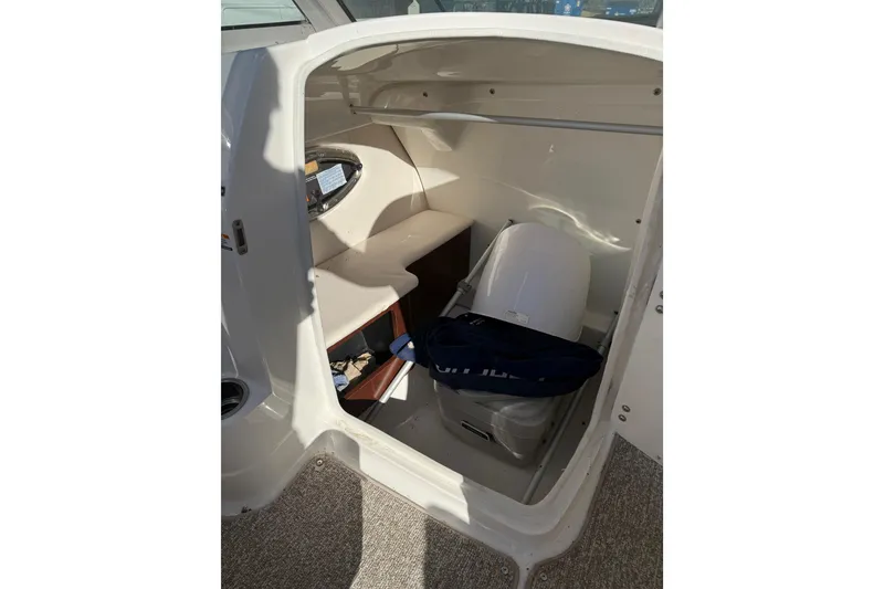 Slide: The Image of Interior cabin of 2015 Chaparral 244 Sunesta boat, featuring storage and seating area. - 13