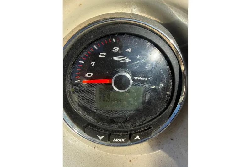 Slide: The Image of Close-up of a 2015 Chaparral 244 Sunesta tachometer displaying RPM and hours. - 16