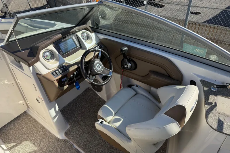 Slide: The Image of 2015 Chaparral 244 Sunesta boat cockpit with steering wheel and dashboard controls. - 17