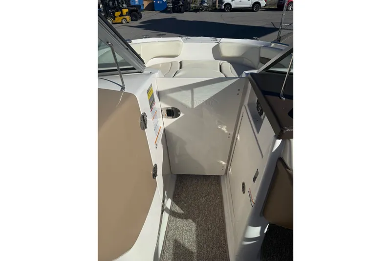 Slide: The Image of 2015 Chaparral 244 Sunesta boat interior with seating and storage compartments. - 18