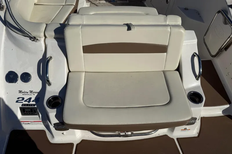 Slide: The Image of 2015 Chaparral 244 Sunesta boat seating area with cup holders and modern design. - 21