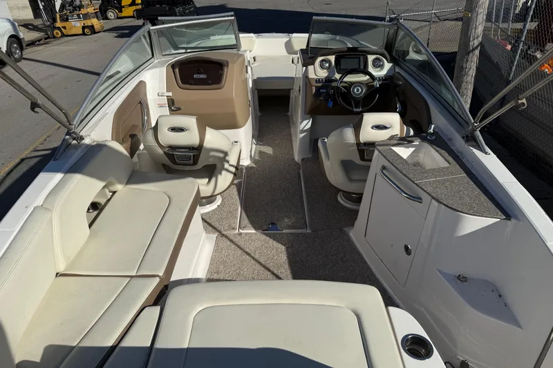 Slide: The Image of 2015 Chaparral 244 Sunesta boat interior with seating and helm. - 23