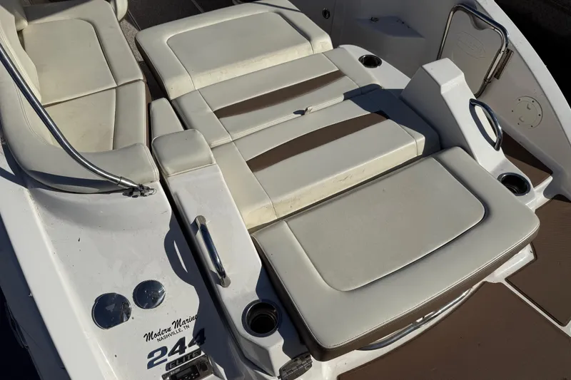 Slide: The Image of 2015 Chaparral 244 Sunesta boat interior with beige seating and cup holders. - 24