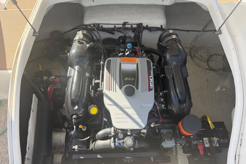 Slide: The Image of Engine compartment of a 2015 Chaparral 244 Sunesta boat, featuring a MerCruiser 350 MAG engine. - 25