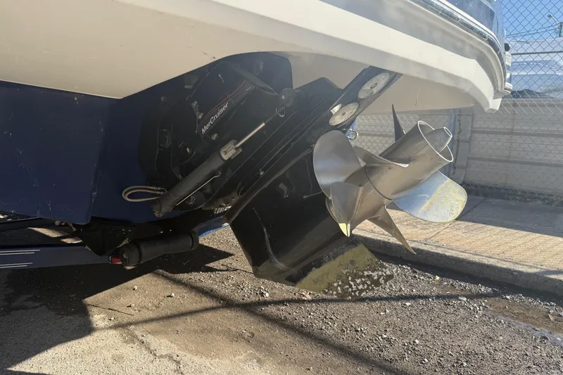 Slide: The Image of 2015 Chaparral 244 Sunesta boat with MerCruiser outdrive and propeller, parked on pavement. - 30