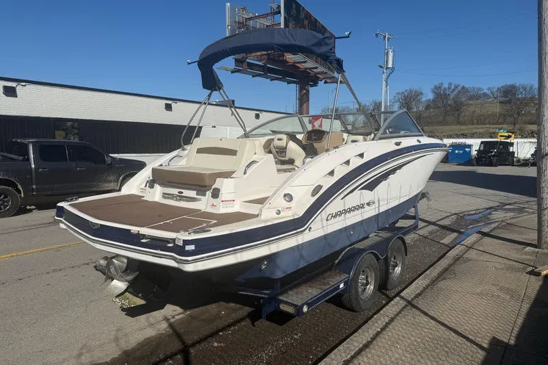 Slide: The Image of 2015 Chaparral 244 Sunesta boat on trailer, parked outdoors under clear sky. - 4