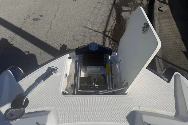 Slide: The Image of Open anchor compartment on 2015 Chaparral 244 Sunesta boat, showing anchor storage. - 6