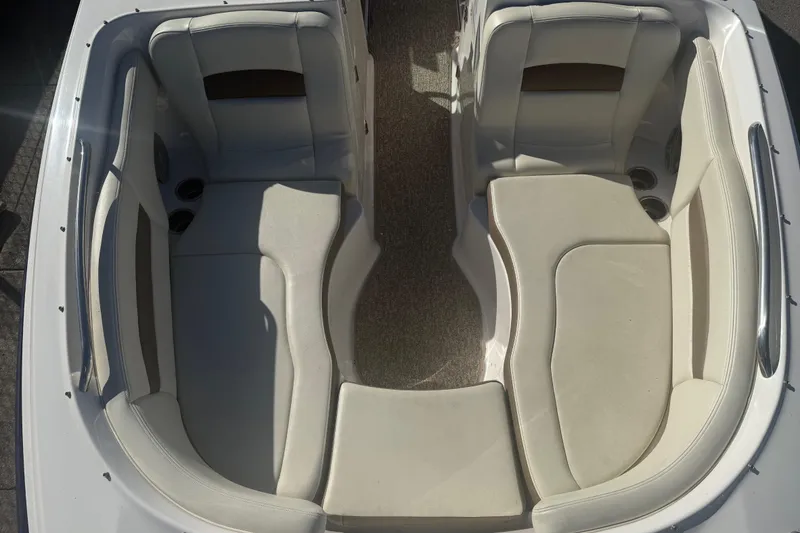 Slide: The Image of 2015 Chaparral 244 Sunesta boat interior with white seating and cup holders. - 7