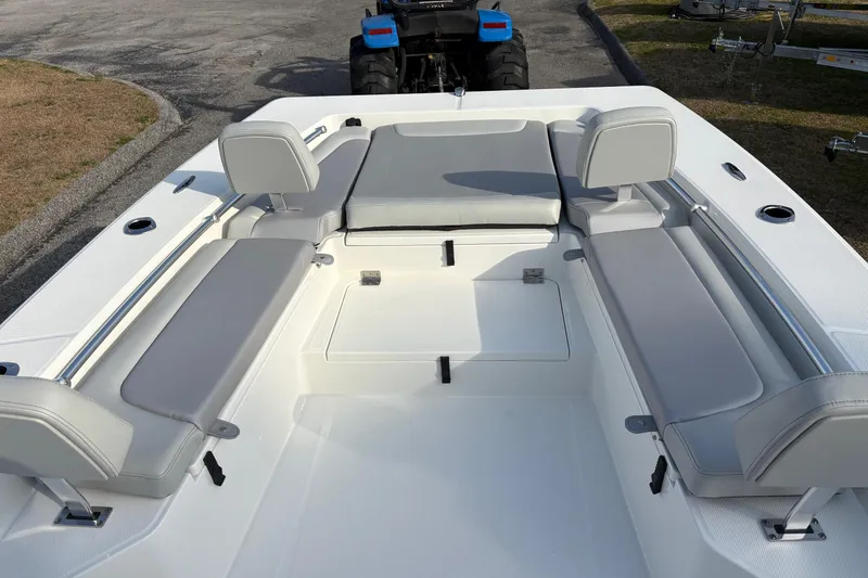 Slide: The Image of 2026 Bay Rider 2460 FS Skiff interior with gray seating and storage compartments. - 14