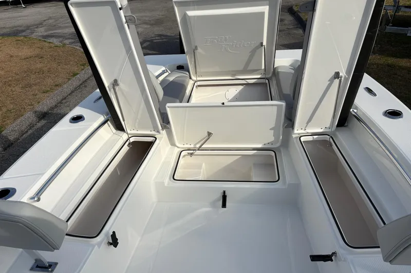 Slide: The Image of 2026 Bay Rider 2460 FS Skiff with open storage compartments on deck. - 16