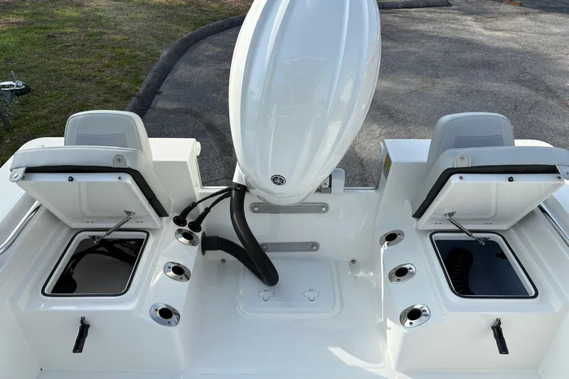 Slide: The Image of 2026 Bay Rider 2460 FS Skiff with open storage compartments and motor. - 7