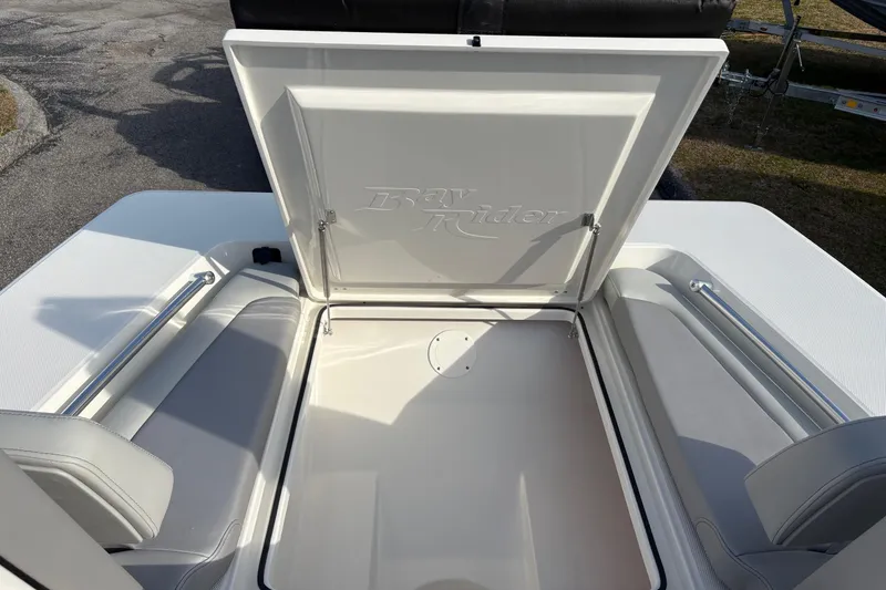 Slide: The Image of Bay Rider 2460 FS Skiff 2026 with open storage compartment lid. - 15