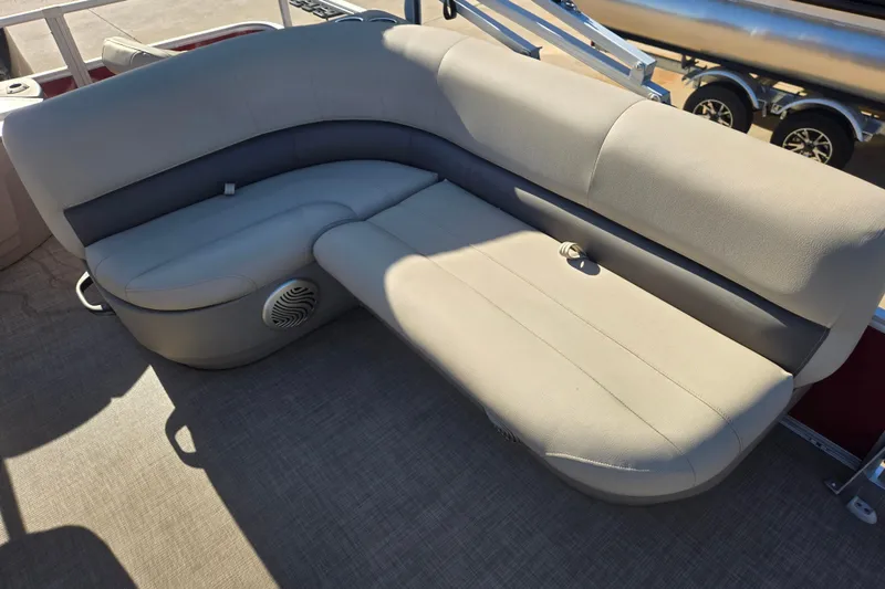 Slide: The Image of 2023 Sun Tracker Bass Buggy 18 DLX pontoon boat seating area with beige upholstery. - 12