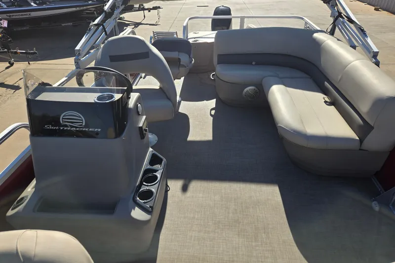 Slide: The Image of 2023 Sun Tracker Bass Buggy 18 DLX pontoon boat interior with seating and console. - 13