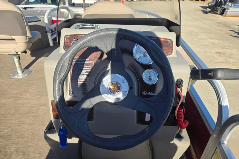 Slide: The Image of 2023 Sun Tracker Bass Buggy 18 DLX steering console with gauges and controls. - 15