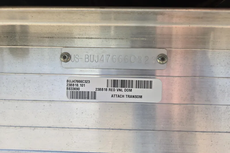 Slide: The Image of 2023 Sun Tracker Bass Buggy 18 DLX identification plate with serial numbers and barcodes. - 18