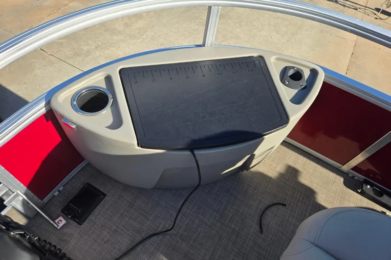 Slide: The Image of 2023 Sun Tracker Bass Buggy 18 DLX boat console with cup holders and measuring board. - 6