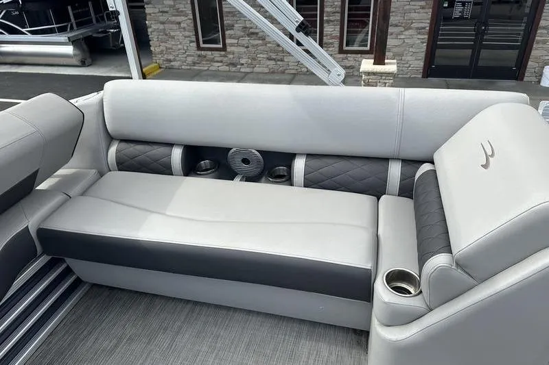 Slide: The Image of 2021 Bennington 21 SSBX boat interior with gray seating and cup holders. - 12