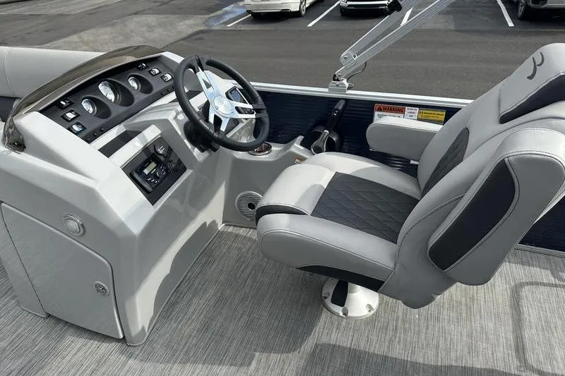 Slide: The Image of 2021 Bennington 21 SSBX boat interior with steering wheel and captain's chair. - 14