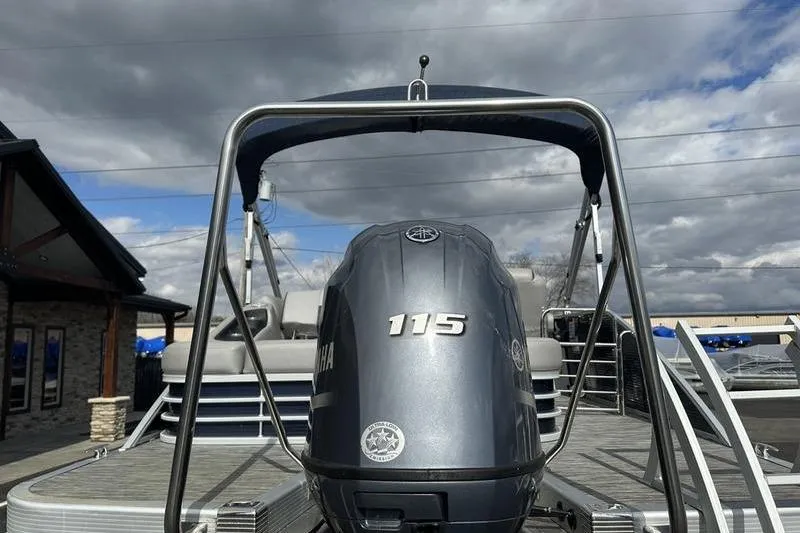 Slide: The Image of 2021 Bennington 21 SSBX pontoon boat with Yamaha 115 engine under cloudy sky. - 4