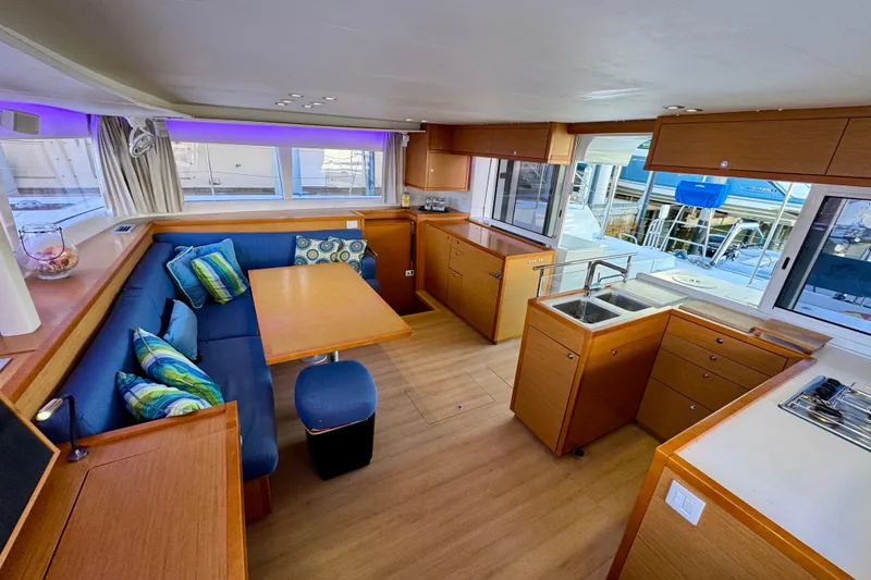 Slide: The Image of Interior of 2012 Lagoon 450 F catamaran with modern kitchen and cozy seating area. - 10
