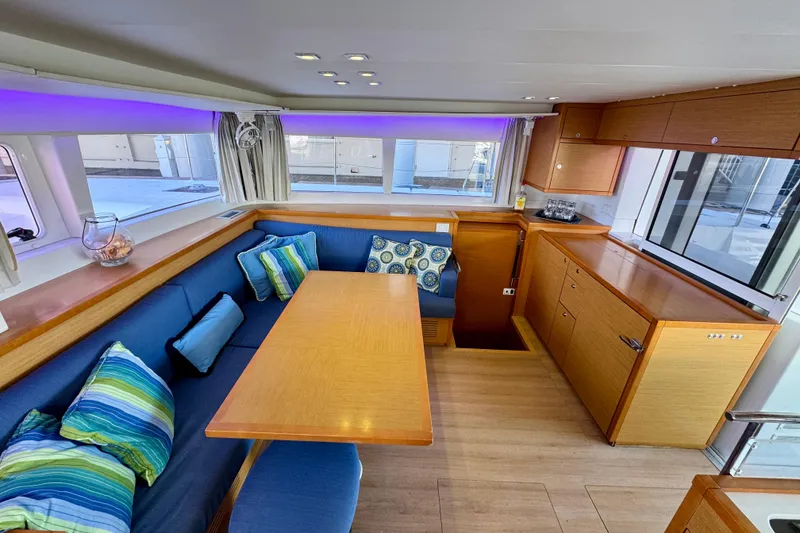 Slide: The Image of Interior of 2012 Lagoon 450 F yacht with cozy seating and vibrant cushions. - 14