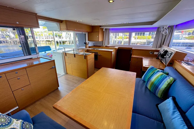 Slide: The Image of Interior of 2012 Lagoon 450 F yacht with modern kitchen and seating area. - 15