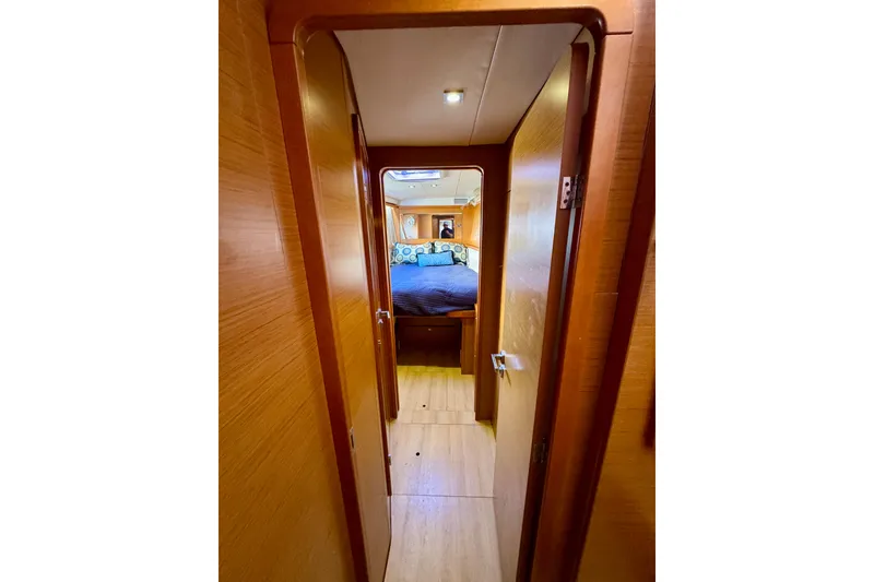 Slide: The Image of Interior hallway of 2012 Lagoon 450 F yacht, leading to a cozy bedroom. - 16