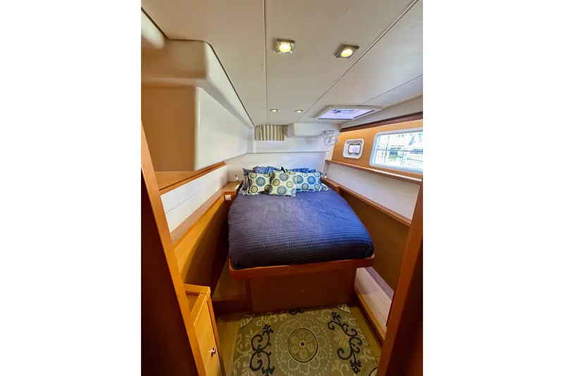 Slide: The Image of Cozy cabin interior of 2012 Lagoon 450 F yacht with bed and porthole. - 18